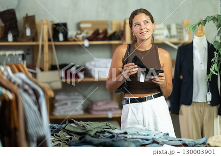 Woman choosing high-heeled shoes in a store 130003901