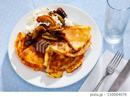 pancakes with cottage cheese served on white plate for breakfast 130004076