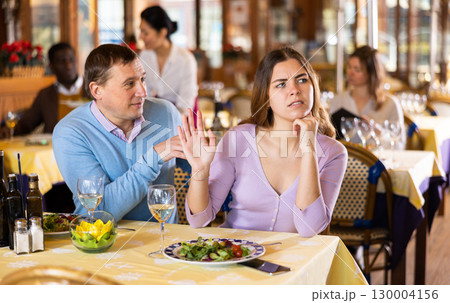 Man and his wife quarreling in restaurant 130004156