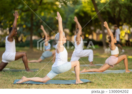 Yoga for people of different ages - elderly woman practicing different yoga poses together in park Yoga for people of different ages - elderly woman practicing different yoga poses together in park 130004202