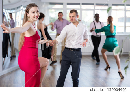 Man and woman practicing swing dance in dancing studio 130004492
