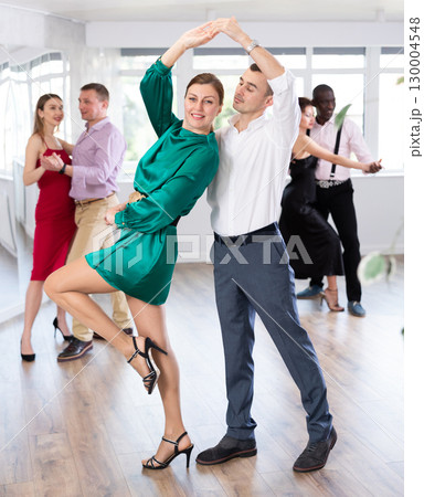 Woman and young man practicing waltz in dancing studio Woman and young man practicing waltz in dancing studio 130004548