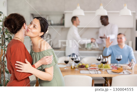 Two women greet each other when meeting 130004555