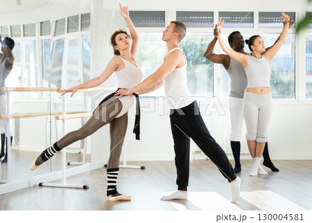 Young man and adult woman rehearsing pair ballet Young man and adult woman rehearsing pair ballet 130004581