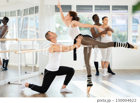 Man and woman rehearsing a couple ballet dance together in studio 130004622