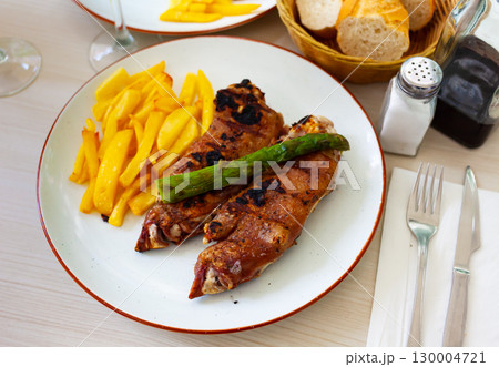 Grilled pettitoes on plate with fried potatoes and asparagus Grilled pettitoes on plate with fried potatoes and asparagus 130004721