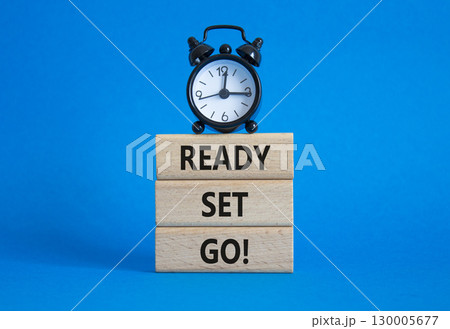 Ready Set Go symbol. Concept words Ready Set Go on wooden blocks. Beautiful blue background with alarm clock. Business and Ready Set Go concept. Copy space. 130005677