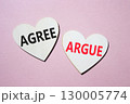 Agree or Argue symbol. Concept word Agree or Argue on wooden hearts. Beautiful pink background. Business and Agree or Argue concept. Copy space 130005774