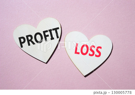 Profit or Loss symbol. Concept word Profit or Loss on wooden hearts. Beautiful pink background. Business and Profit or Loss concept. Copy space Profit or Loss symbol. Concept word Profit or Loss on wooden hearts. Beautiful pink background. Business and Profit or Loss concept. Copy space 130005778