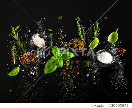 AI generated Rosemary oregano thyme black pepper and salt burst in whole and powdered forms colliding dramatically midair against pure black background Perfect for gourmet cooking meat preparation 130005941