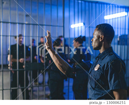 AI generated A uniformed police officer stands at the frame edge gesturing authoritatively toward a jail cell in a police station The scene conveys law enforcement security and justice system themes 130006251