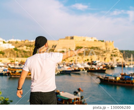 AI generated A sailor stands at the edge of the frame gesturing toward a bustling harbor with ships and docks. The scene conveys adventure, travel, and maritime life with a warm, inviting atmosphere. 130006280