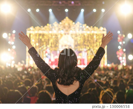 AI generated A radiant beauty queen stands at the frame edge gesturing toward a sparkling pageant stage with spotlights. The dazzling backdrop evokes elegance, competition and dream-come-true moments 130006558