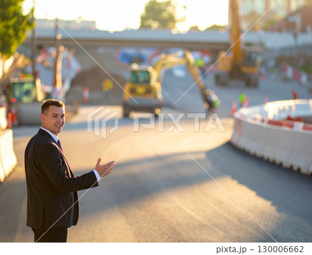 AI generated A professional civil engineer stands at the frame edge gesturing toward an active road construction site. The infrastructure development scene showcases urban planning, engineering 130006662