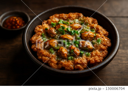 AI generated image of a rustic Thai dish featuring crispy fried mussels served with a side of chili sauce. The rich textures and warm colors evoke comfort, freshness, and a touch of spice. 130006704