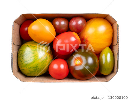 Fresh and ripe tomatoes of various varieties, colors, and sizes in a cardboard punnet. Varieties of the plant Solanum lycopersicum, whose fruits are edible berries and are eaten as vegetables. Photo Fresh and ripe tomatoes of various varieties, colors, and sizes in a cardboard punnet. Varieties of the plant Solanum lycopersicum, whose fruits are edible berries and are eaten as vegetables. Photo 130008100