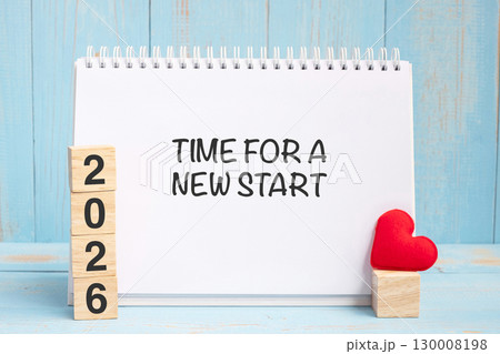 Time for A New Start words and 2026 cubes with red heart shape decoration on blue wooden table background.  130008198