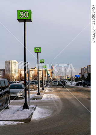 Multi-row car park with number signs on high speed. Car park in winter. Multi-row car park with number signs on high speed. Car park in winter. 130009457
