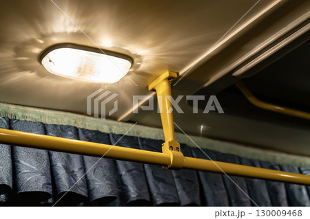 Lighting lamp on the ceiling of the bus above the handrail. Lighting lamp on the ceiling of the bus above the handrail. 130009468