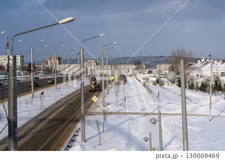 Snow covered pedestrian alley near multi lane highway. Snow covered pedestrian alley near multi lane highway. 130009469