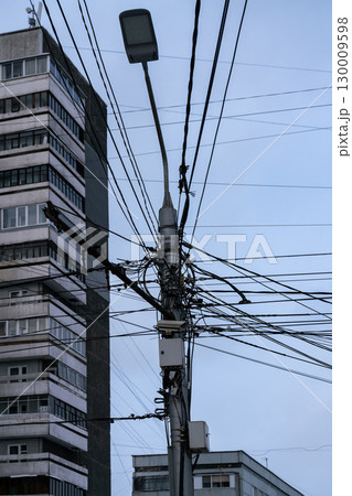 A lantern in a city with a lot of wires. Electrification of megacities. 130009598