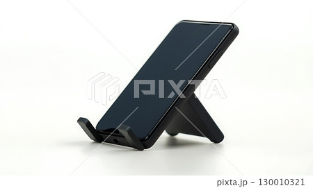 A black cell phone is sitting on a stand 130010321