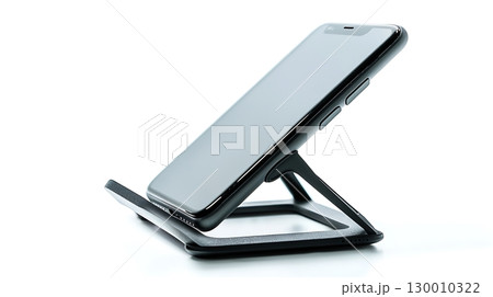 A phone is sitting on a stand with the screen facing up 130010322