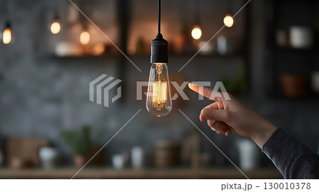 A hand pointing at a light bulb 130010378