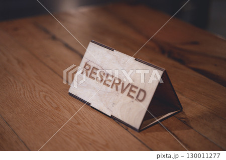 Reserved Sign on Cafe Table. Atmosphere of Anticipation and Elegance Reserved Sign on Cafe Table. Atmosphere of Anticipation and Elegance 130011277