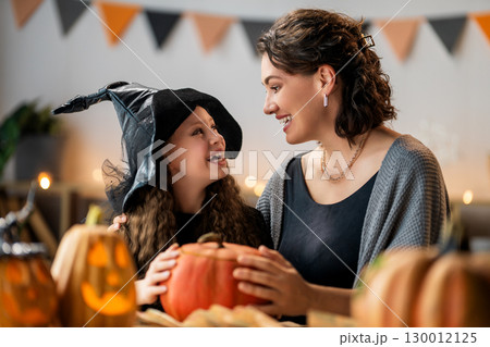 Happy family preparing for Halloween. Happy family preparing for Halloween. 130012125