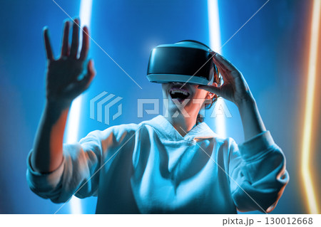 Woman with VR virtual reality goggles 130012668