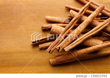 Cinnamon sticks dried tree bark spice on rustic wooden table background. 130013701
