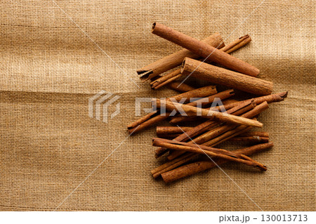 Cinnamon sticks dried tree bark spice on rustic background. 130013713
