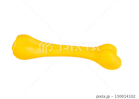 Yellow plastic toy bone isolated on white background. Dog chew toy, durable rubber for pets 130014102
