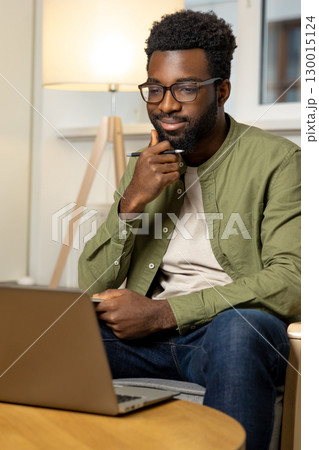 African american young man working on a laptop African american young man working on a laptop 130015124