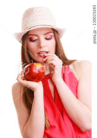 Woman summer hat colorful makeup holds apple fruit Woman summer hat colorful makeup holds apple fruit 130015265