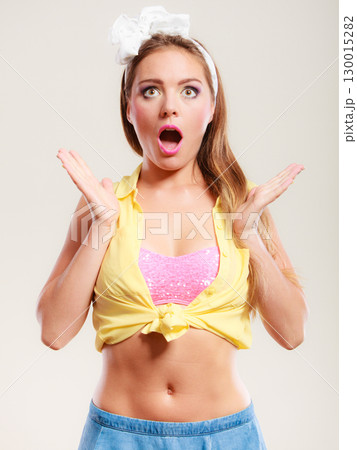 Amazed surprised pin up girl with mouth wide open. 130015282