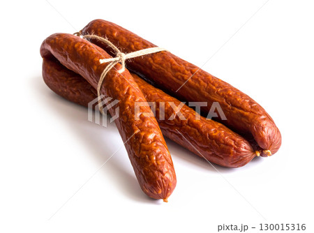 Smoked sausages tied with string lying on white background 130015316