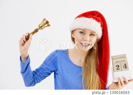 Christmas woman holding calendar and bell Christmas woman holding calendar and bell 130016083