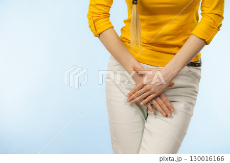 Woman with hands holding her crotch Woman with hands holding her crotch 130016166