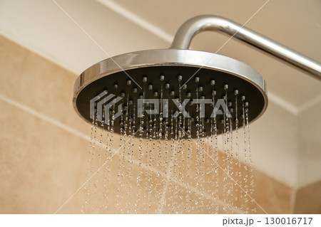 Chrome shower head with water droplets. Increasing water bills. 130016717