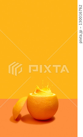 Orange with splash of juice in half peel on orange background 130016762
