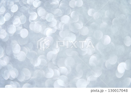 Abstract silver bokeh lights on soft gray background with circular blurred 130017048