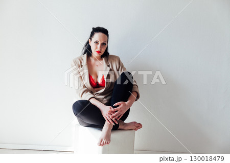 woman in jacket and red bra on white background 130018479