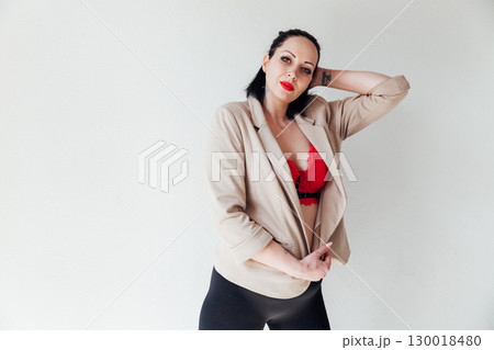 woman in jacket and red bra on white background 130018480