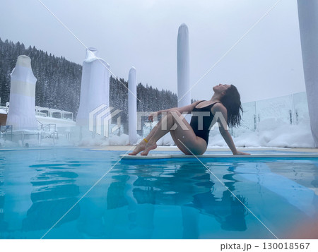 Winter Poolside Relaxation in Snowy Landscape 130018567