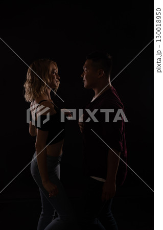 Man and woman dancing to music in the dark 130018950