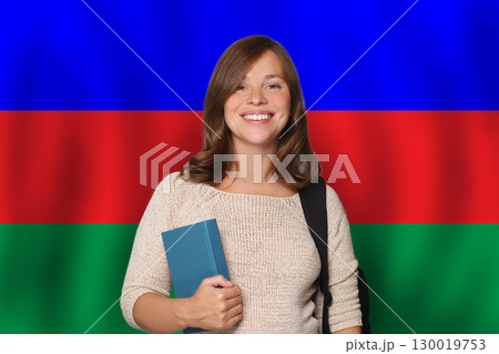 Pretty woman student against Azeri flag background. Travel, education and learn language 130019753