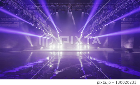 Spectacular light show on stage with reflective floor in concert venue 130020233