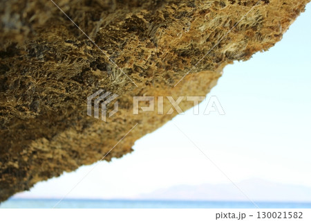Coastal Rock Overhang with a Stunning Ocean View and Distant Horizon 130021582